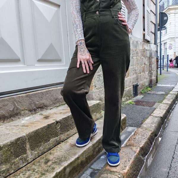 Combinaison longue sans manches Robes / Combinaisons / Salopettes Mademoiselle Hélène Combinaison longue sans manches en velours côtelé vert. Coupe longue, col chemise structuré, fermeture boutonnée sur le devant, poches poitrine et poches latérales, taille marquée pour une silhouette féminine.