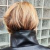 Veste simili cuir noire structurée, effet cuir texturé, coupe oversize, col montant avec boutons, fermeture zip frontal avec rabat asymétrique. Taille unique