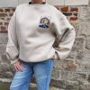 Sweat oversize imprimé soleil, disponible en noir et beige. manches longue, col rond. Taille unique (convient du 34 au 42)